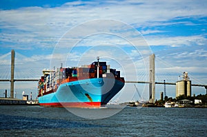 Cargo ship sailing under the bridge photo