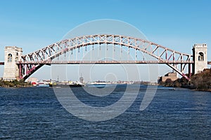 Cargo ship sails under a bridge