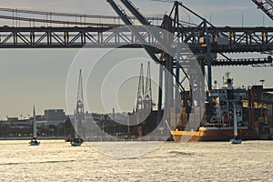 A cargo ship stands at the seaport in early evening