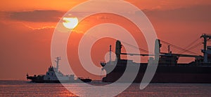 Cargo ship and sunset at the ocean