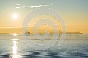 Cargo ship at sunset in the sea