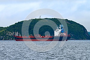 Cargo ship  tanker red on the background of mountains