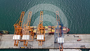 cargo ship and truck at seaport waiting for container dock by crane shipment harbor loading container import export commercial