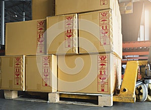 Cargo shipment boxes, Manufacturing and warehousing. Stack of cardboard boxes on pallet at the warehouse storage.