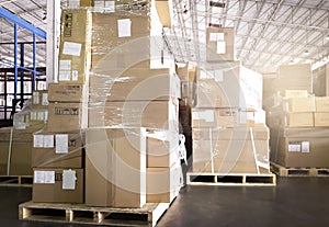 Cargo shipment boxes. Stacked of package boxes on pallet rack at the warehouse storage. Manufacturing and warehousing.