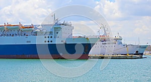 Cargo ships anchored on the docks of a harbor