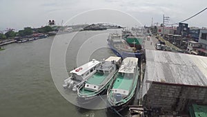 Cargo ships docked on huge Pasig river to unload their goods