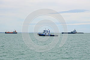 Cargo ships on the ocean near island