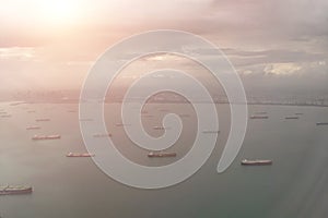 Cargo ships in the port of Singapore. View from above. Aerial view to the shore and sea from the plane