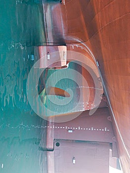A cargo ships propeller come out of sea