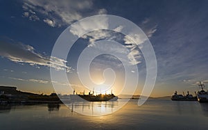 Cargo ships silhouettes at the sunrise