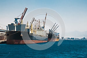 Cargo ships stand in the port of Eilat