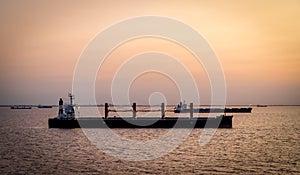 Cargo ships at sunset