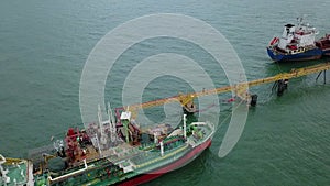 Cargo tanker ship marine vessel docking and oversea berth mooring platform for petroleum and crude oil industry from aerial view