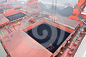 Cargo terminal for discharging coal cargos by shore cranes during foggy weather. Port Bayuquan,China.