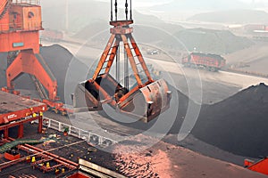 Cargo terminal for discharging coal cargos by shore cranes during foggy weather. Port Bayuquan,China. photo