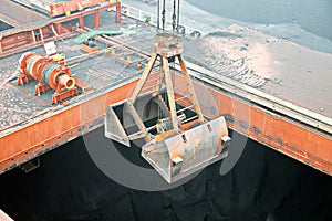 Cargo terminal for discharging coal cargos by shore cranes during foggy weather. Port Bayuquan,China. photo