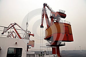 Cargo terminal for discharging coal cargos by shore cranes during foggy weather. Port Bayuquan,China. photo