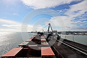 Cargo terminal for loading coal cargos by shore cranes. Port Gladstone, Australia. December, 2019.