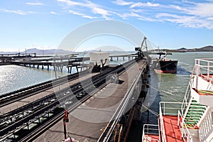 Cargo terminal for loading coal cargos by shore cranes. Port Gladstone, Australia. December, 2019.