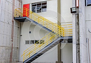 At the cargo terminal in the old Galeao airport, white building, ladder with yellow railing and red door. Rio de Janeiro, Brazil