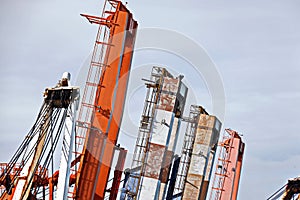 Cargo terminal for unloading steel plates from bulk carrier by ships cranes.  Port of Cigading. Indonesia, December, 2020.