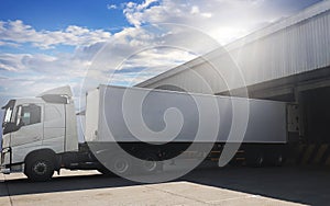 Cargo Trailer Truck Parked Loading at Dock Warehouse. Cargo Shipment. Induatry Freight Truck Transportation.