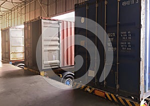 Cargo trailer truck parked loading at dock warehouse. Cargo shipment. Industry freight truck transportation.