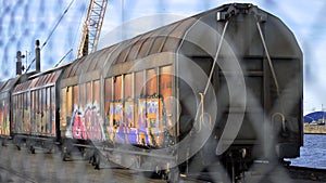 Cargo train behind fence.