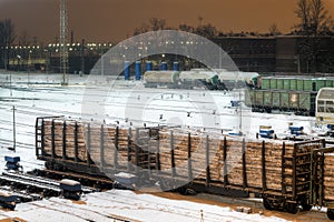 Cargo train carrying wood at night