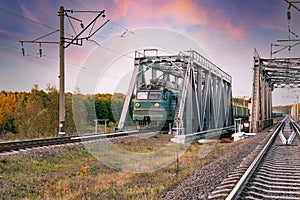 Cargo train on a metal bridge in motion