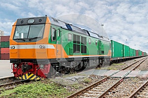Cargo train platform with freight train container at depot in po