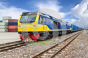 Cargo train platform with freight train container at depot.