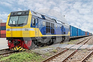 Cargo train platform with freight train container at depot in po