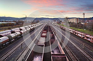Cargo train platform at sunset with container