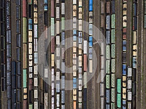 Cargo trains close-up. Aerial view of colorful freight trains on the railway station. Wagons with goods on railroad