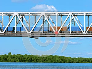 Cargo transportation by rail, freight train on the bridge