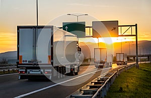 Cargo trucks on the road with sunset