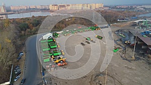 Cargo vehicles stand in a row on a parking lot near the factory warehouse. freight transportation