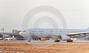 Cargo white aircraft without airline`s livery and logo on the runway