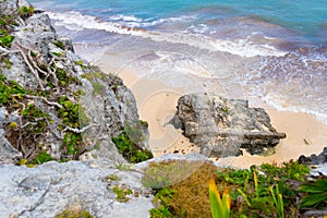 Caribbean coast near Tulum. Turquoise sea and blue sky. Nature with rocks and plants. Travel photo, background. Yucatan. Quintana