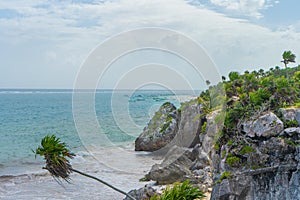 Caribbean coast near Tulum. Turquoise sea and blue sky. Nature with rocks and plants. Travel photo, background. Yucatan. Quintana