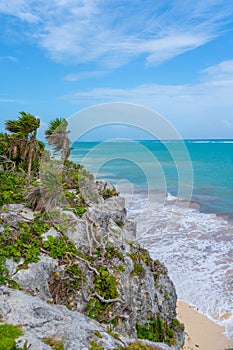 Caribbean coast near Tulum. Turquoise sea and blue sky. Nature with rocks and plants. Travel photo, background. Yucatan. Quintana