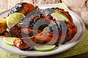Caribbean grilled chicken drumstick with lime and onions closeup photo
