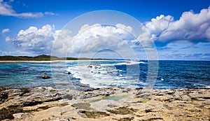 Caribbean Ocean Tropical Seascape with Blue Cloudy Sky and Rocky Beach. Panorama and Holidays