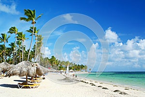 Caribbean resort beach with umbrellas and chairs