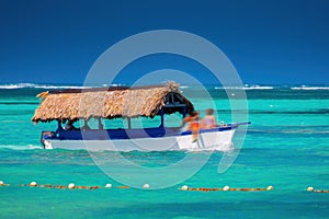 Caribbean sea and sailing boat on the water, hot summer day on the Caribe. Punta Cana, Dominican Republic photo