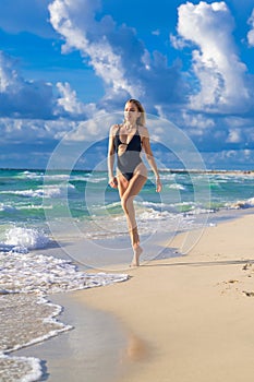 Caribbean sea. Sexy tanned girl in bikini swimsuit on sea background. Fashion woman in bikini relax on beach. Happy