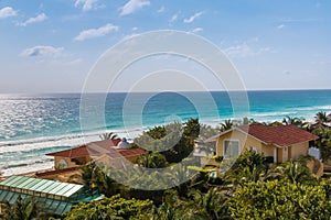 Caribbean tropical style houses on sea shore. Cancun, Mexico