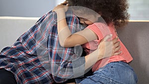 Caring adult lady hugging little girl, child adoption system, family happiness photo